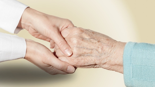 holding hands of nursing home resident